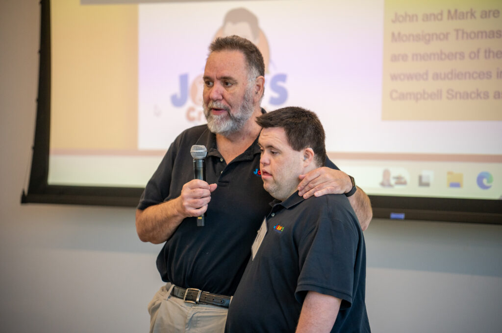 John and Mark holding a microphone