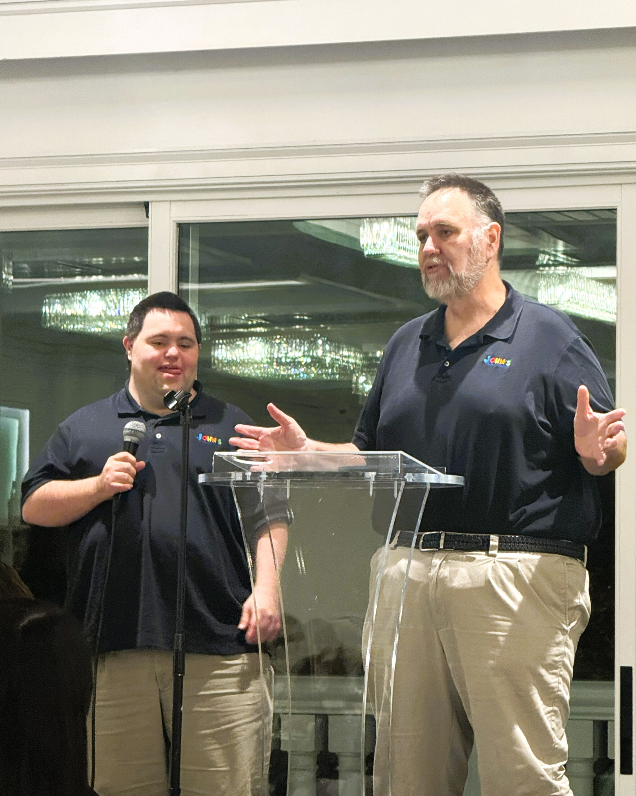 John and Mark at a microphone speaking